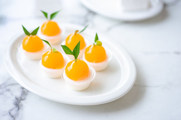 Orange jellies are decorated on a plate of orange-like characteristics. Has a sweet and sour taste