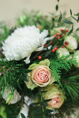 close up winter bridal bouquet with white roses, chrysanthemum, pine, thuja, ilex, pistachio, above side view of stock photo image