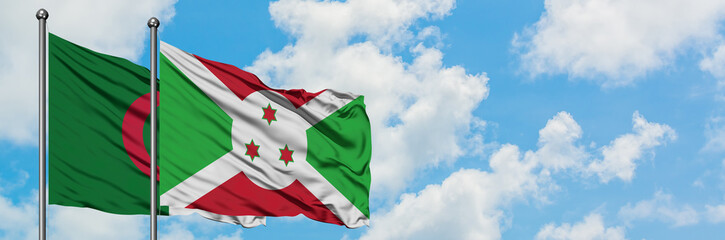 Algeria and Burundi flag waving in the wind against white cloudy blue sky together. Diplomacy concept, international relations.