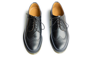 A genuine leather black brogues isolated on a white background. Smart casual style shoes