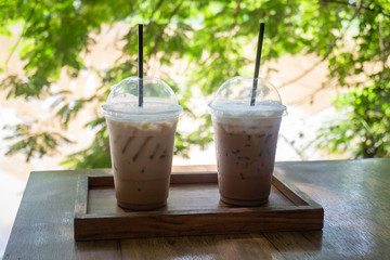Iced coffee on wooden outdoors table