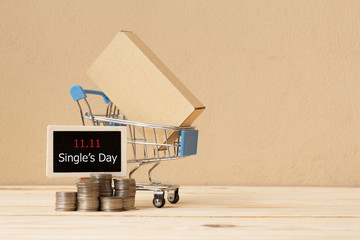 Online shopping of China, 11.11 single's day sale concept. The box in shopping cart , coin and the text 11.11 single's day sale.