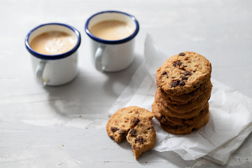 coffee and cookies with chocolate chips on ceramic background