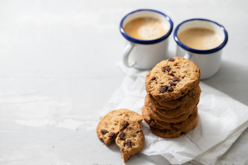 coffee and cookies with chocolate chips on ceramic background