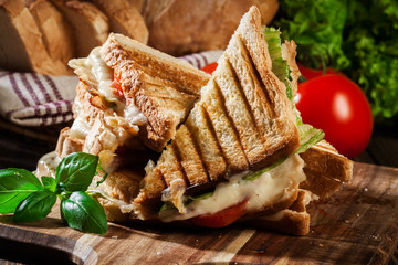 Stack of panini with ham, cheese and lettuce sandwich