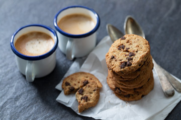 coffee and cookies with chocolate chips on ceramic background