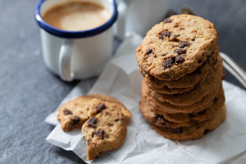 coffee and cookies with chocolate chips on ceramic background