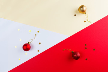 Christmas gift box on multicolored paper background.