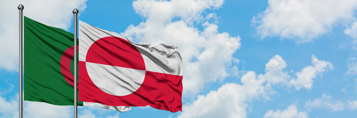 Algeria and Greenland flag waving in the wind against white cloudy blue sky together. Diplomacy concept, international relations.