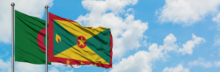 Algeria and Grenada flag waving in the wind against white cloudy blue sky together. Diplomacy concept, international relations.