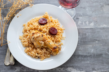 chicken with smoked sausage and rice on white plate