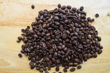 Coffee bean on natural wood table with great texture and ambiance background for menu or cafe or design material elements