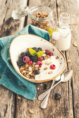 Cereal breakfast with fresh blackberries, raspberries and pumpkin seeds. Healthy food. Selective focus.