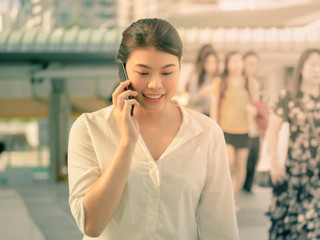 Fototapeta premium Professional business woman smiling calling smartphone urban city downtown