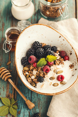 Homemade granola with raspberries and blackberries. Healthy food.