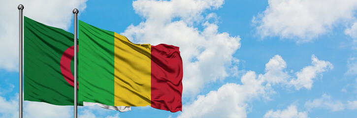 Algeria and Mali flag waving in the wind against white cloudy blue sky together. Diplomacy concept, international relations.