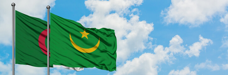 Algeria and Mauritania flag waving in the wind against white cloudy blue sky together. Diplomacy concept, international relations.