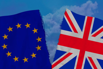 two colored flags on torn fabric, a symbol of international relations of the European Union and Great Britain, the concept of global business, the deterioration of political relations, brexit