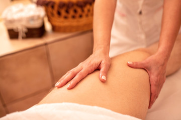 Obraz na płótnie Canvas Thigh massage in close up view