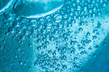 Abstract colorful background. Foam of Soap with Bubbles macro shot. Closeup bubbles in water. Oil...