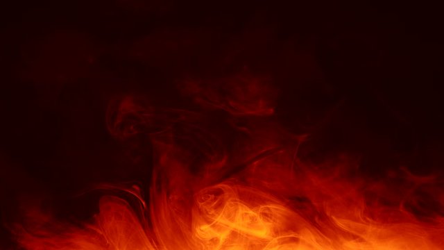 Smoke flow animation. Glowing bonfire flames. Red orange hot fume motion on dark background.