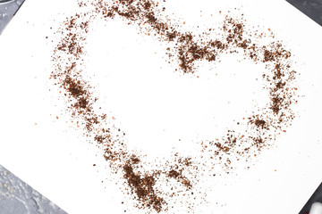 Coconut, coffee, chocolate scrub in the shape of a heart on white background. Care, love, Valentine's day concept