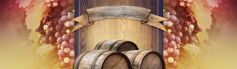 Wine background with a wooden signboard, bunches of red grape and oak barrels. Template of billboard with grapevine and old casks for a presentation of alcohol drinks, wine making industry or winery.