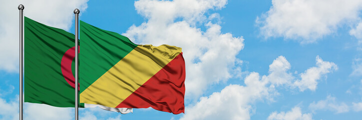 Algeria and Republic Of The Congo flag waving in the wind against white cloudy blue sky together. Diplomacy concept, international relations.