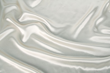 Obraz premium soft folds on delicate white shiny silk, luxury concept, background for the designer, horizontal, close-up, copy space