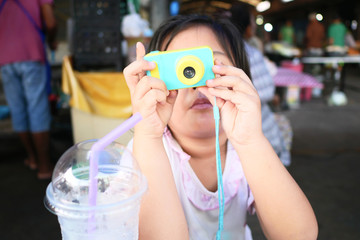 portrait of a girl with toy camera 