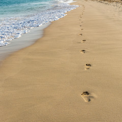 Footsteps on golden sand