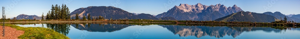 Wall mural high resolution stitched panorama of a beautiful alpine view with reflections in a lake at fieberbru