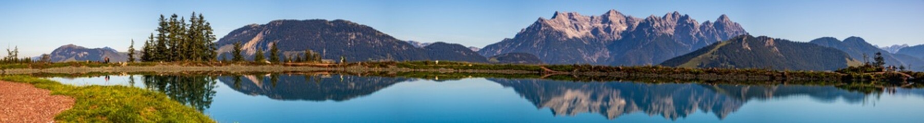 High resolution stitched panorama of a beautiful alpine view with reflections in a lake at Fieberbrunn, Tyrol, Austria - obrazy, fototapety, plakaty