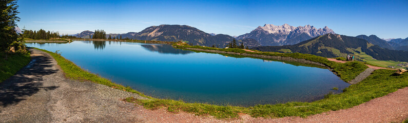 Fototapeta premium High resolution stitched panorama of a beautiful alpine view with reflections in a lake at Fieberbrunn, Tyrol, Austria