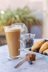 prepares coffee with milk with ciabatta in his coffee shop