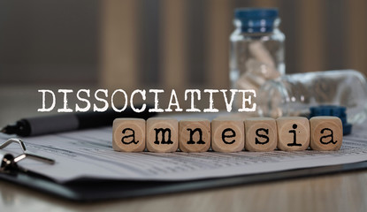 Word DISSOCIATIVE AMNESIA composed of wooden dices. - obrazy, fototapety, plakaty