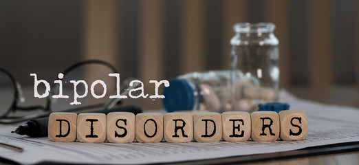 Words BIPOLAR DISORDERS composed of wooden dices.