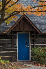 Fototapeta na wymiar blue door log cabin autumn