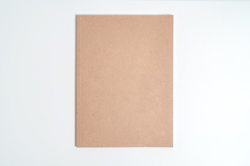 Brown spiral notebook isolated on white background.top view