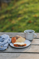 Scythe with poppy seeds, butter and tea. Baking with poppy seeds and coffee. The work of a baker. Poppy seed baking and pies.Bakery, cook together. Bun with butter on the nature in the forest. Picnic