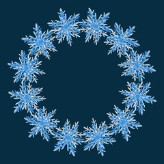 Winter wreath of blue snowflakes on dark blue background. Cold weather winter symbols