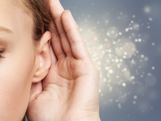 Girl listening with her hand on an