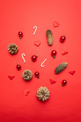 Border made of red background with pine cones, Christmas decoration silver stars, candy canes on red background.