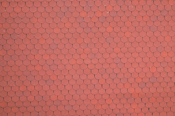 Close up view on red bitumen asphalt roof shingles background.