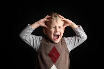  Little blond boy 3-4 years old surprised by something, pretty crazy expression. Background shot in studio with soft lights with an interesting expression and dramatic. 