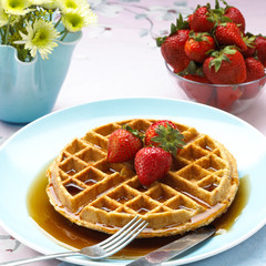 Belgian Waffle with strawberries and syrup