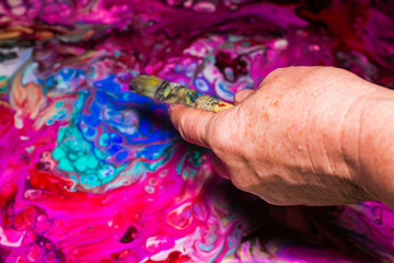 Woman paints an abstract picture