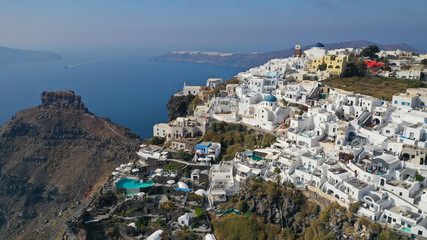 Fototapeta na wymiar Aerial drone photo of iconic picturesque village of Imerovigli built on top of steep hill with amazing views to Caldera and Santorini island, Cyclades, Greece