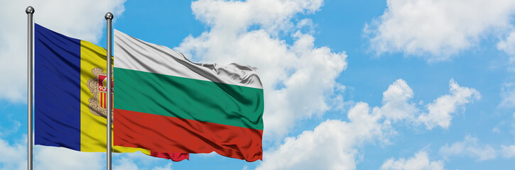 Andorra and Bulgaria flag waving in the wind against white cloudy blue sky together. Diplomacy concept, international relations.