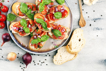 fresh tomato bruschetta. italian food appetizer with basil on table